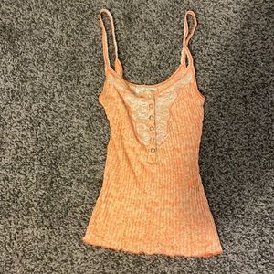 Free People light orange cami with lace detail.